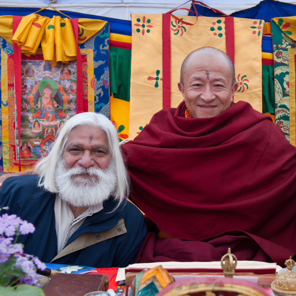 Dzongsar Khyentse Rinpoche is smiling while seated on a throne and around Suresh Jindal.